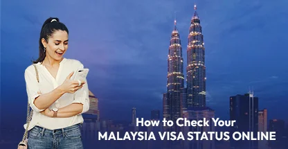 Woman checking Malaysia visa status online on smartphone with Petronas Twin Towers in background